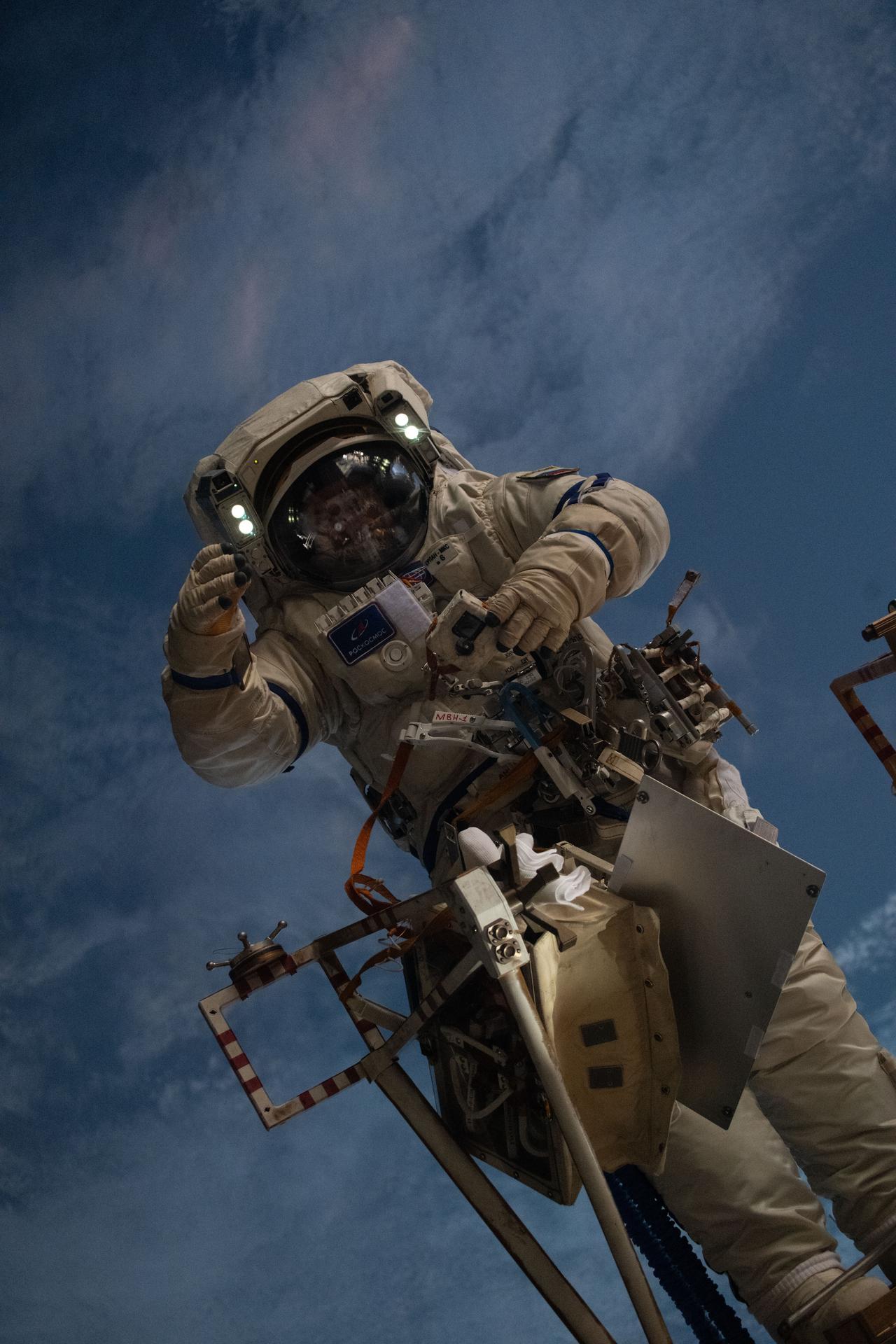 Astronaut performing a spacewalk with Earth visible in the background